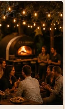 Guests dining together at an evening private party lit by string lights